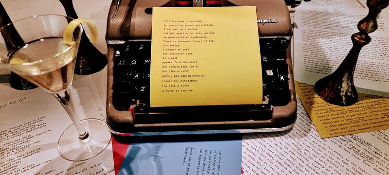 God and the Roadhouse — a typewritten poem on a yellow note in an Olympia typewriter, beginning 'With the best intentions'.