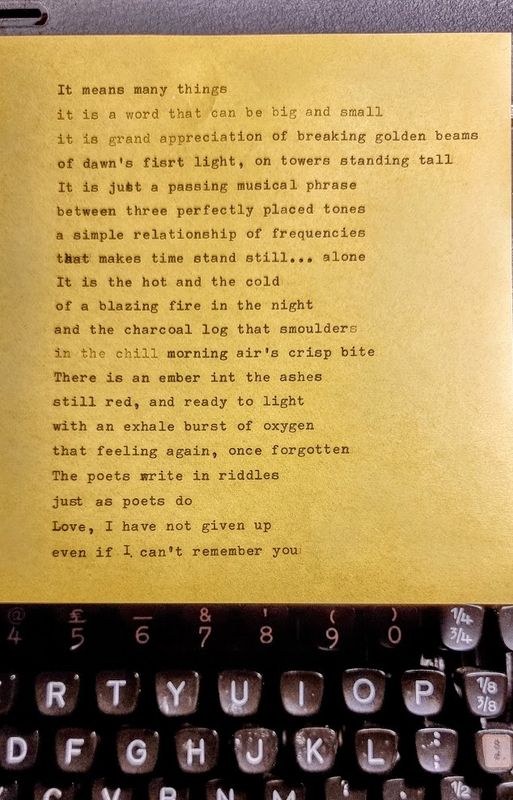 Poet's Ember — a typewritten poem on gold paper beginning 'It means many things'.